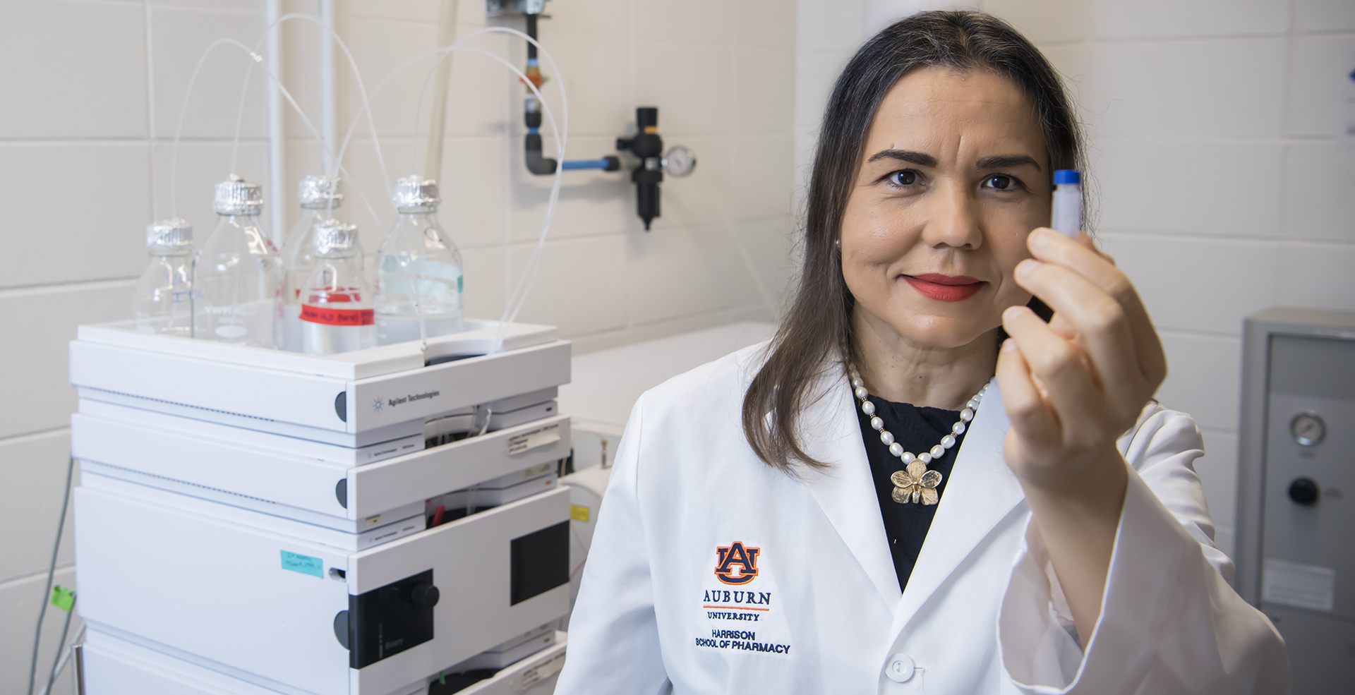 Dr. Calderon holds a vial in her lab