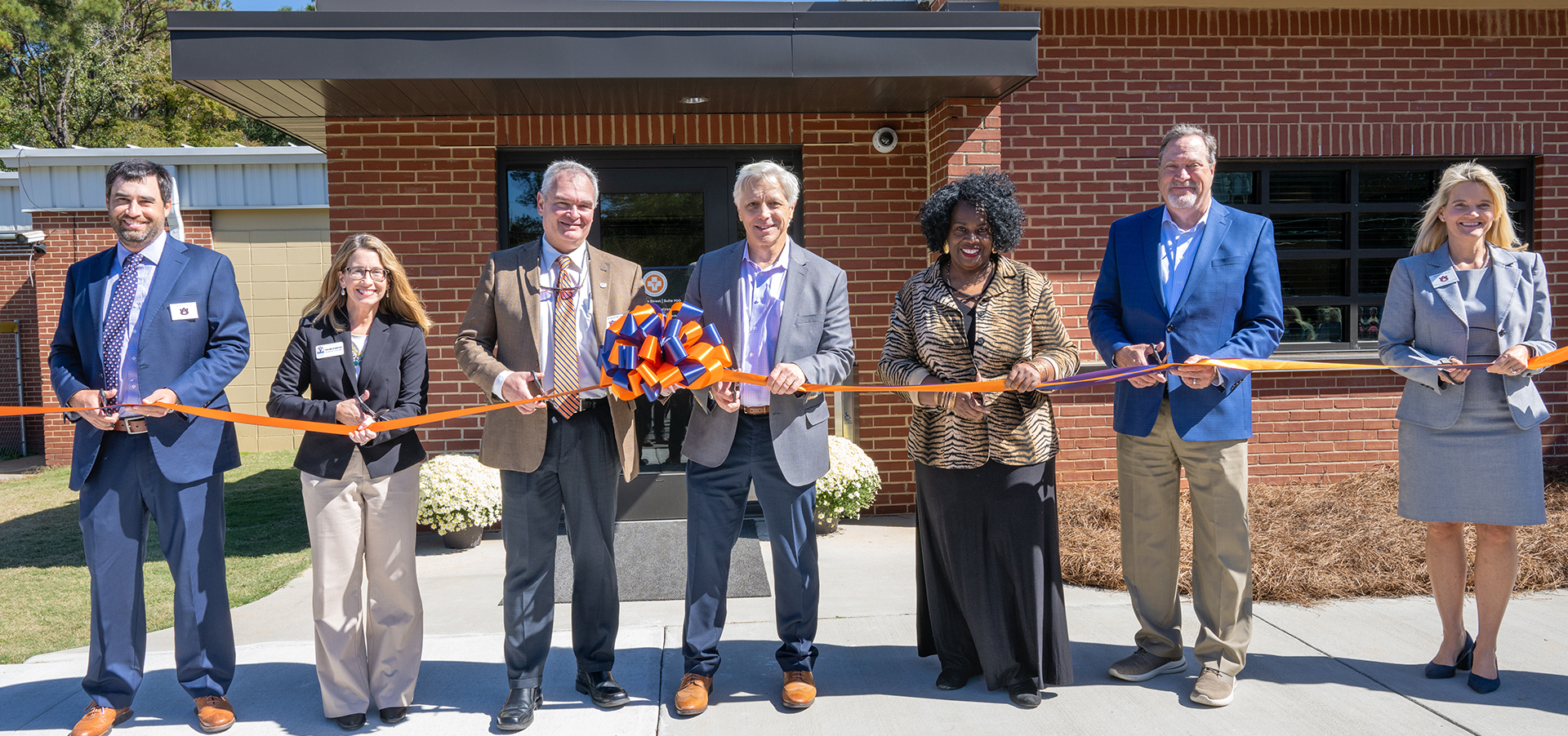 Group of people cut a ribbon