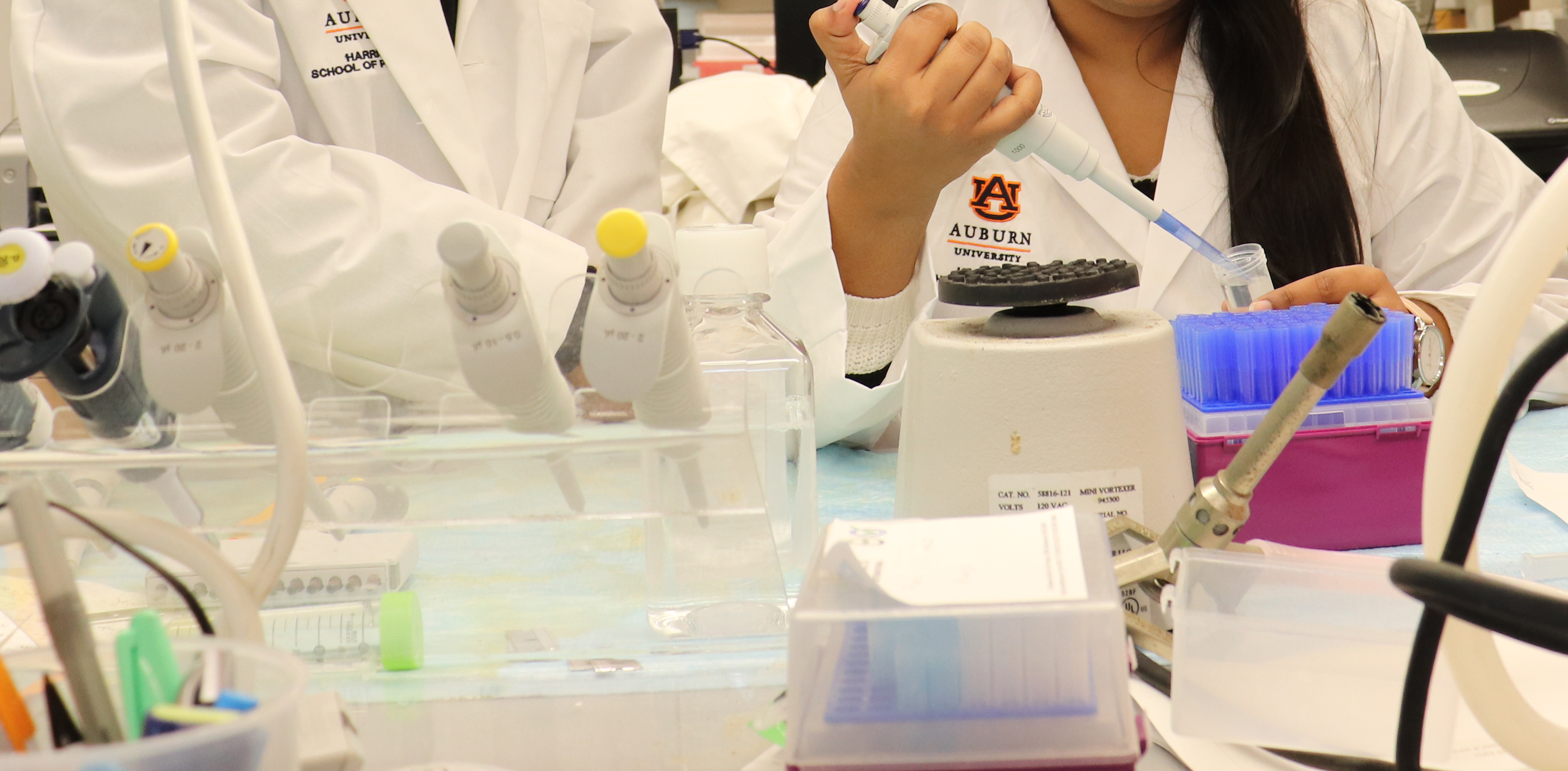Student and faculty member at research bench in lab