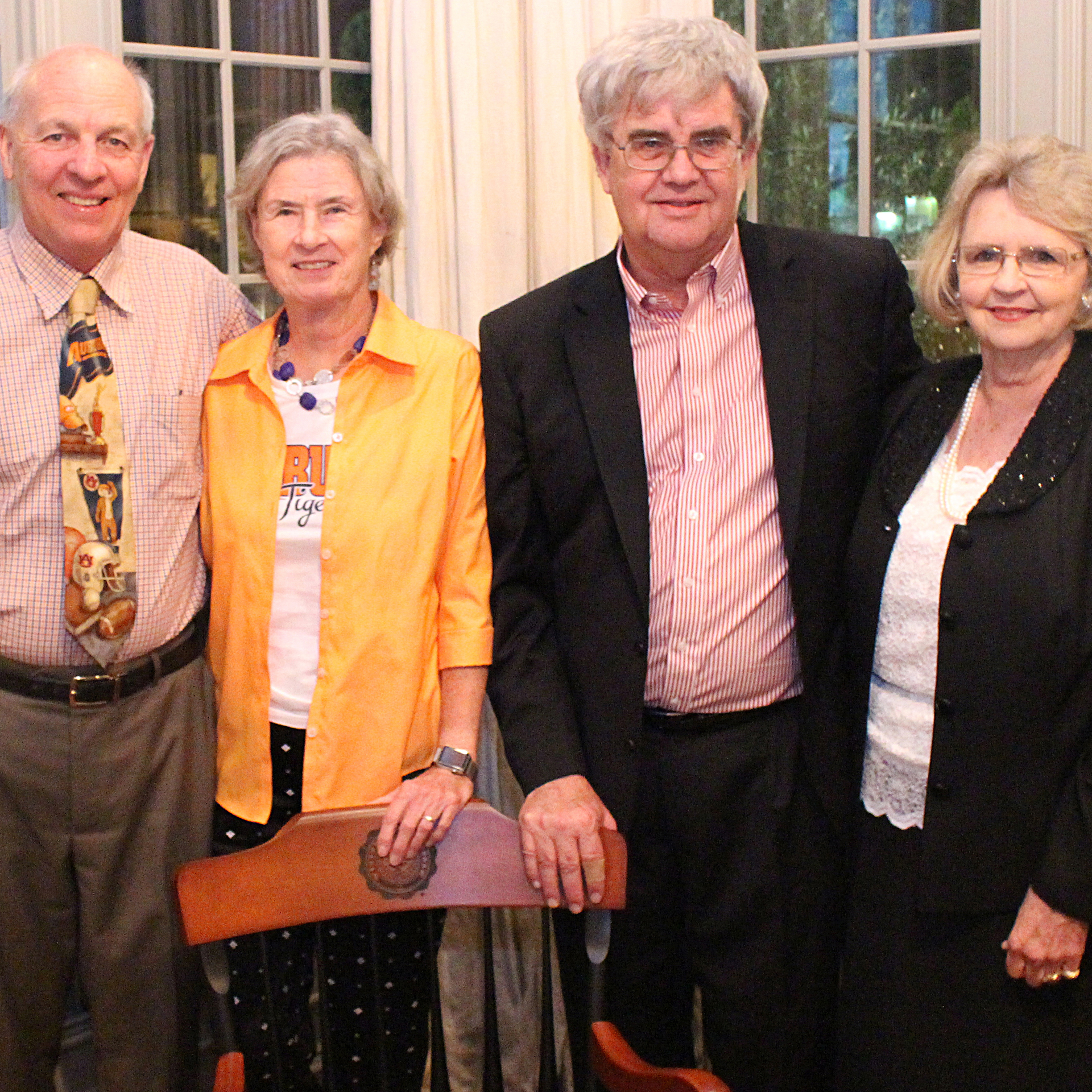 Group of four people stand together