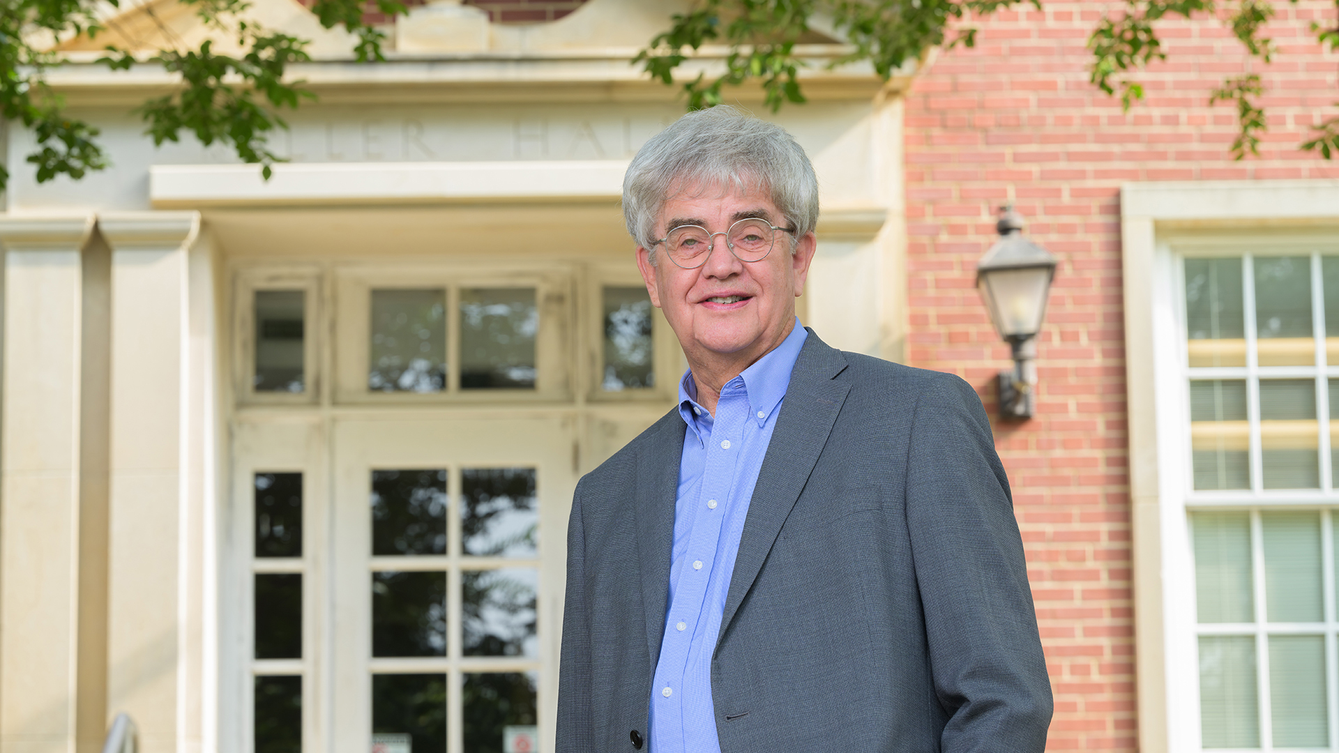 Dr. Clark stands in front of building