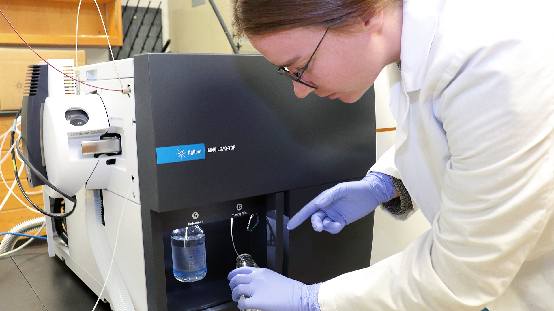 Person works on mass spectrometer