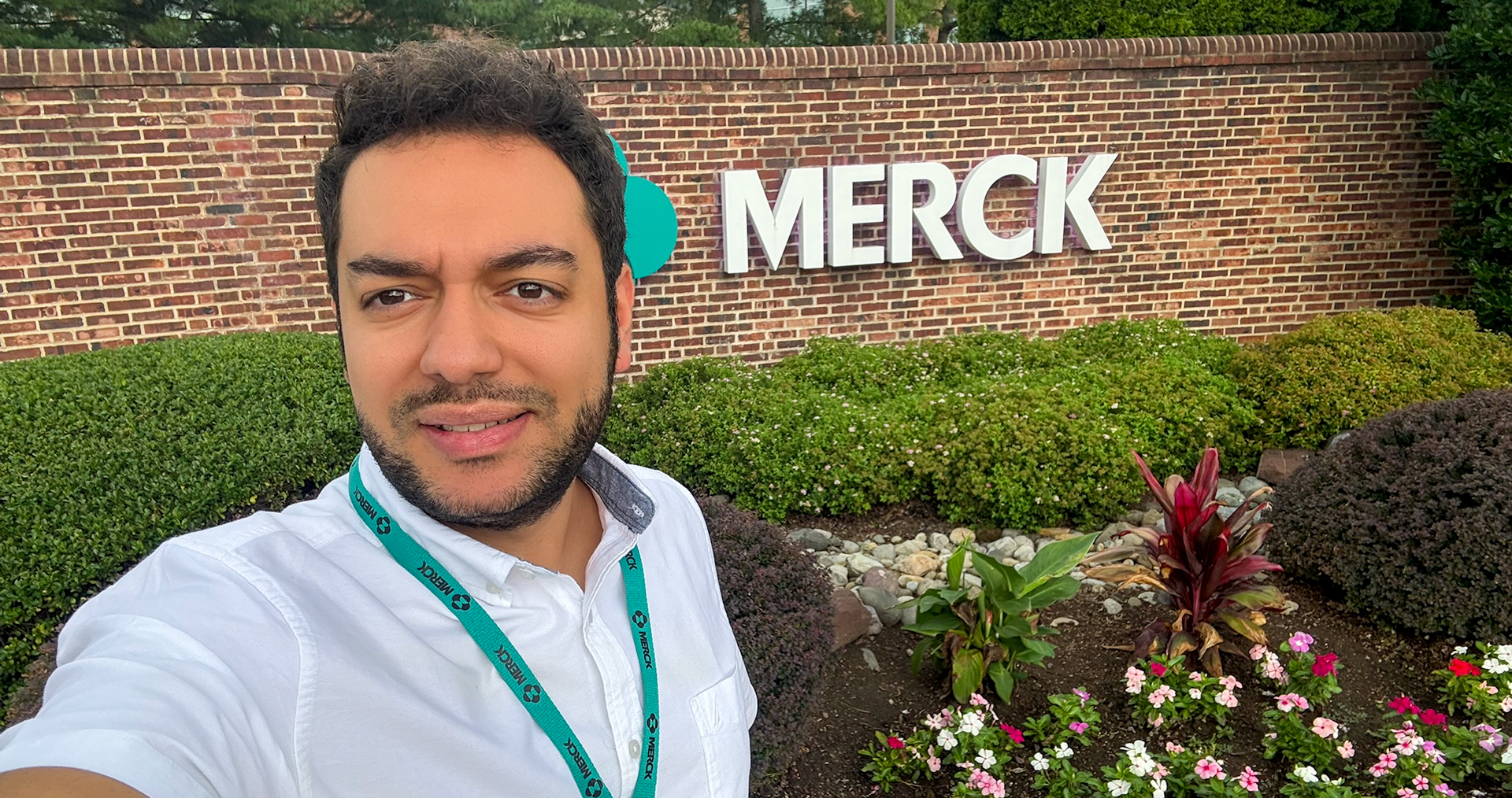 Person takes selfie in front of sign