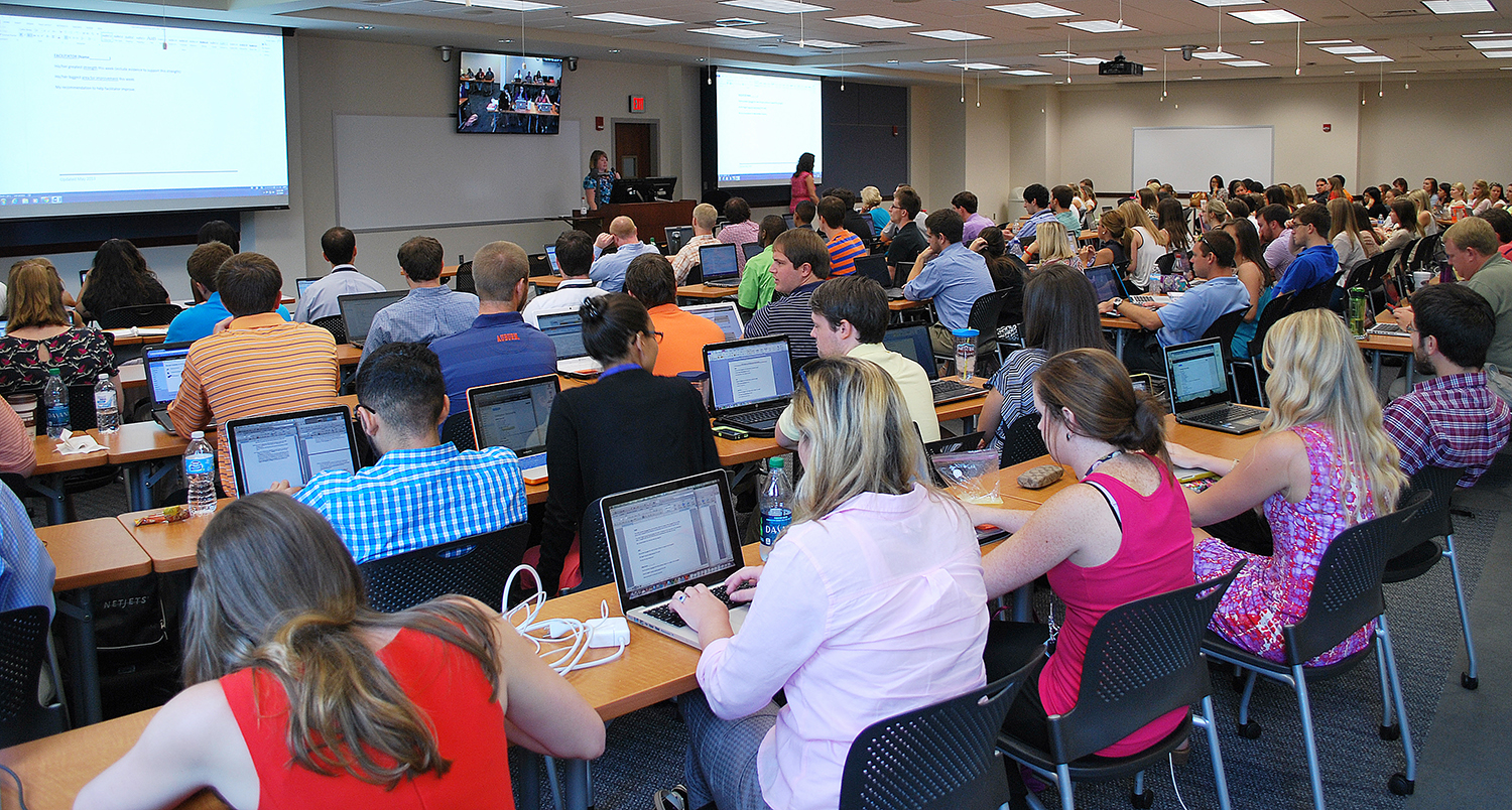 Students in classroom with laptops open